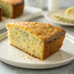 Naturally delicious slice of lemon poppy cake with visible poppy seeds.